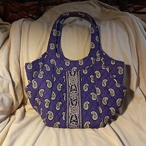 Vera Bradley purple paisley quilted fabric bag with side pockets.